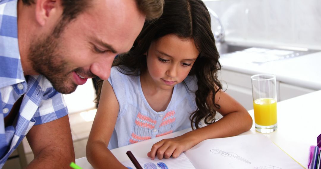 Father and Daughter Drawing Together at Table - Free Images, Stock Photos and Pictures on Pikwizard.com