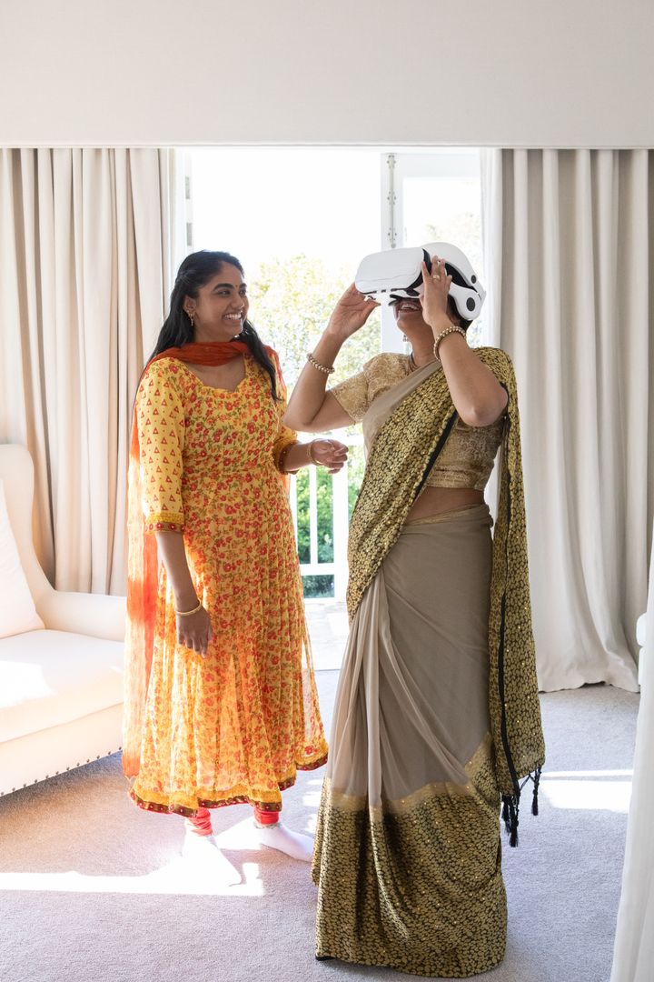 Indian Mother and Daughter Using VR Headset Happy Pose in Modern Home