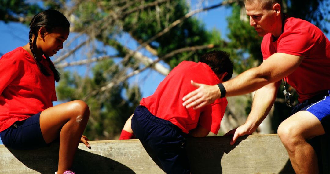 Children with Trainer Overcoming Obstacle in Outdoor Activity - Free Images, Stock Photos and Pictures on Pikwizard.com