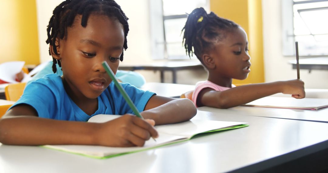 African American children focused on schoolwork in classroom - Free Images, Stock Photos and Pictures on Pikwizard.com