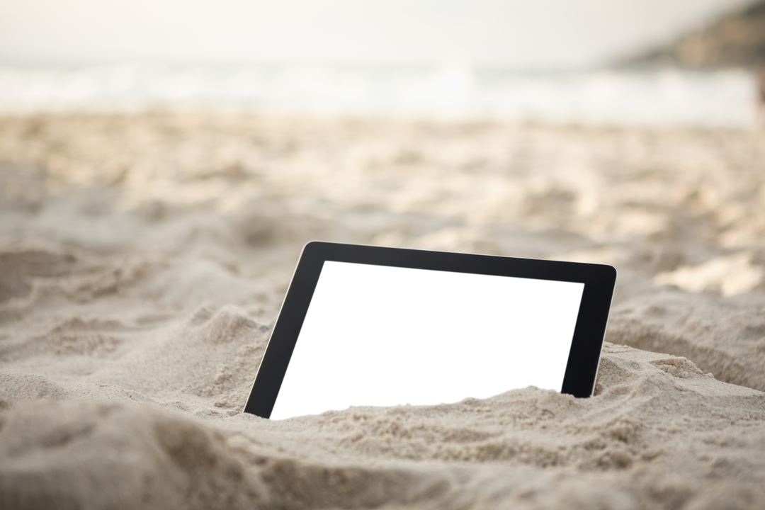 Transparent digital tablet resting in sand on sunny beach - Download Free Stock Images Pikwizard.com