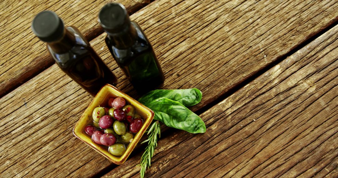 Rustic Table with Olives, Herbs, and Olive Oil
