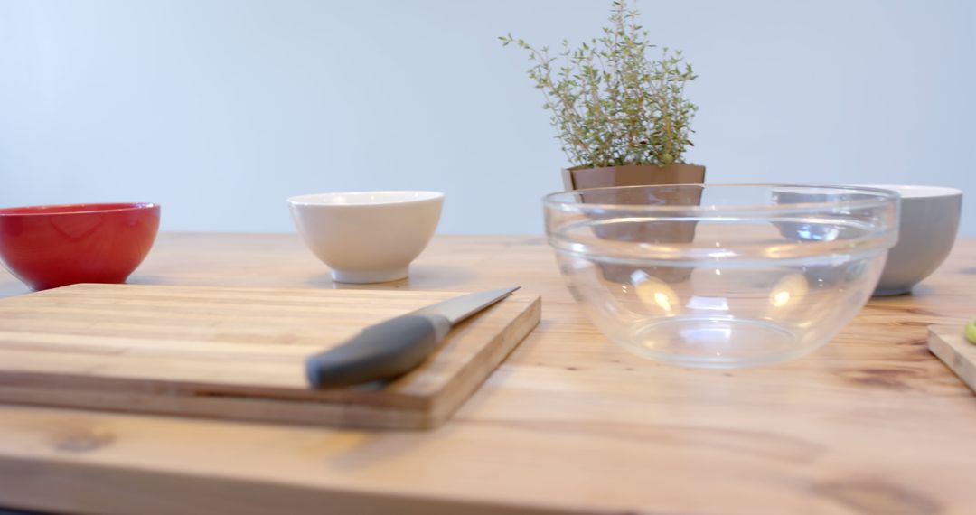 Minimalist Kitchen Table with Bowls, Cutting Board, and Knife - Free Images, Stock Photos and Pictures on Pikwizard.com