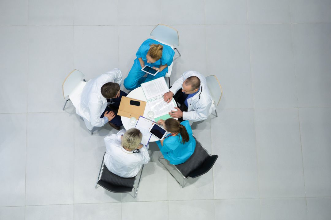 High angle view of doctors and surgeons interacting with each other in meeting - Free Images, Stock Photos and Pictures on Pikwizard.com