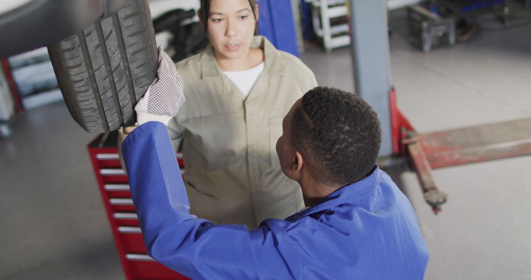 Auto Mechanic Discussing Tire Maintenance with Apprentice - Free Images, Stock Photos and Pictures on Pikwizard.com