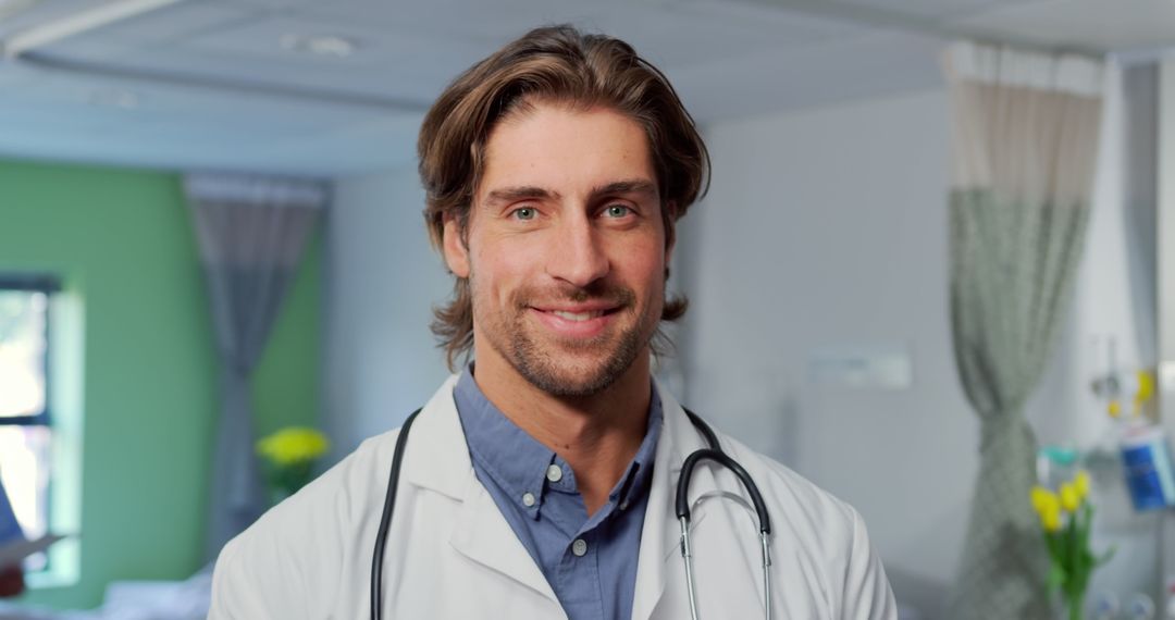 Confident Male Doctor Smiling in Hospital - Free Images, Stock Photos and Pictures on Pikwizard.com