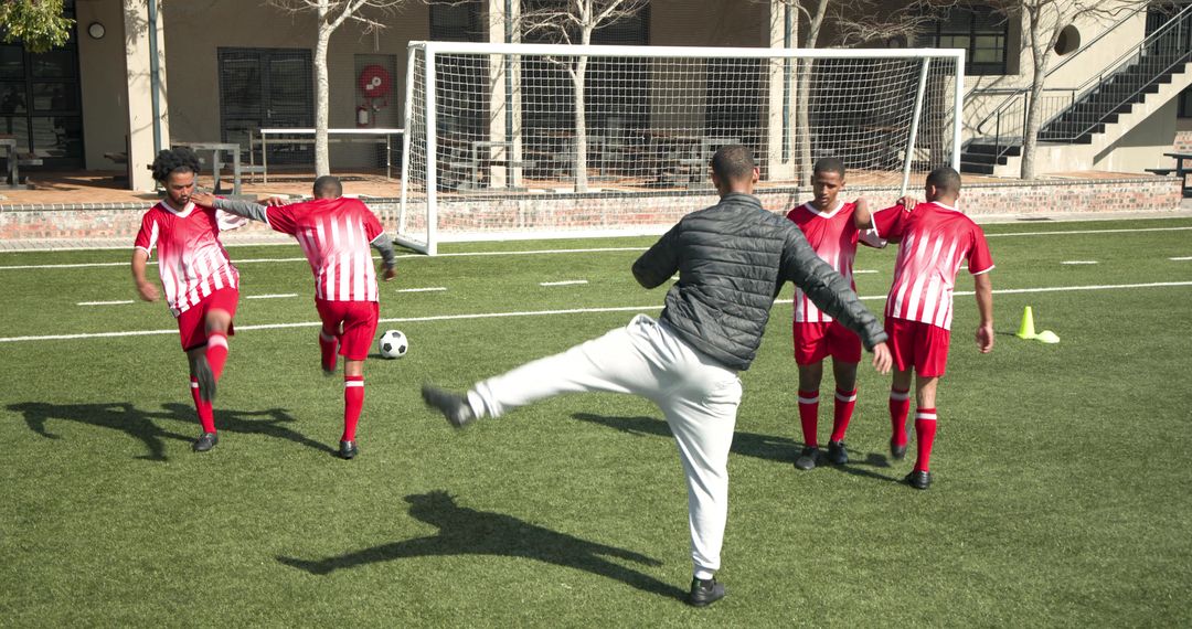 Soccer Coach Teaching Young Players During Training Session