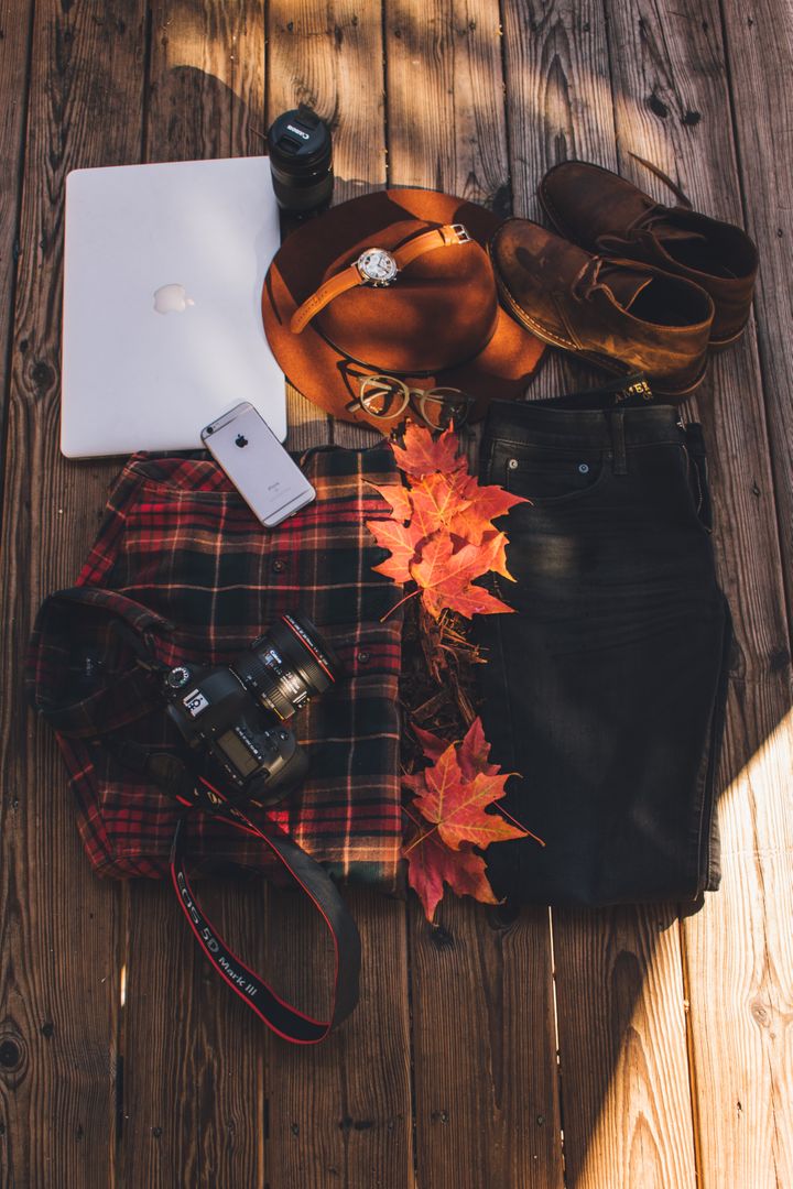 Flat Lay of Travel Essentials with Fall Leaves and Wooden Background - Free Images, Stock Photos and Pictures on Pikwizard.com