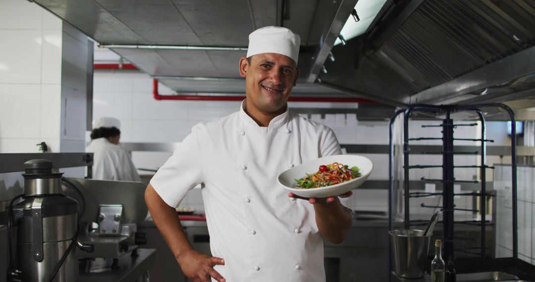 Smiling Chef Presenting a Freshly Made Salad in a Professional Kitchen - Free Images, Stock Photos and Pictures on Pikwizard.com