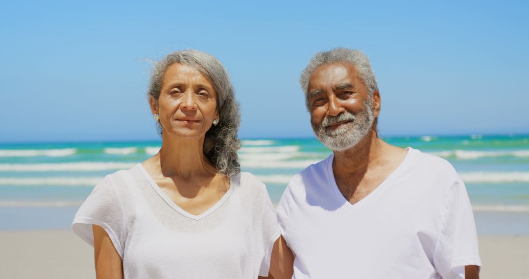 Senior African American Couple Enjoying Beach Day in White Attire