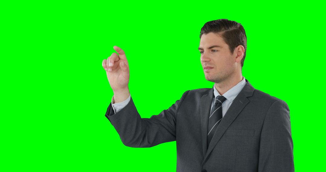 Businessman Touching Invisible Screen on Green Background - Free Images, Stock Photos and Pictures on Pikwizard.com