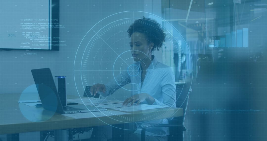 Professional woman reviewing documents and typing on laptop with AR HUD data dashboard in office