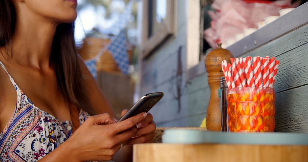 Woman Using Smartphone Near Food Truck with Colorful Straws - Free Images, Stock Photos and Pictures on Pikwizard.com