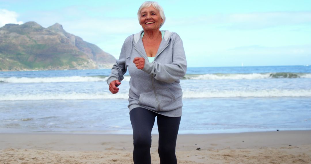 Senior Woman Exercising on Beach in Morning - Free Images, Stock Photos and Pictures on Pikwizard.com