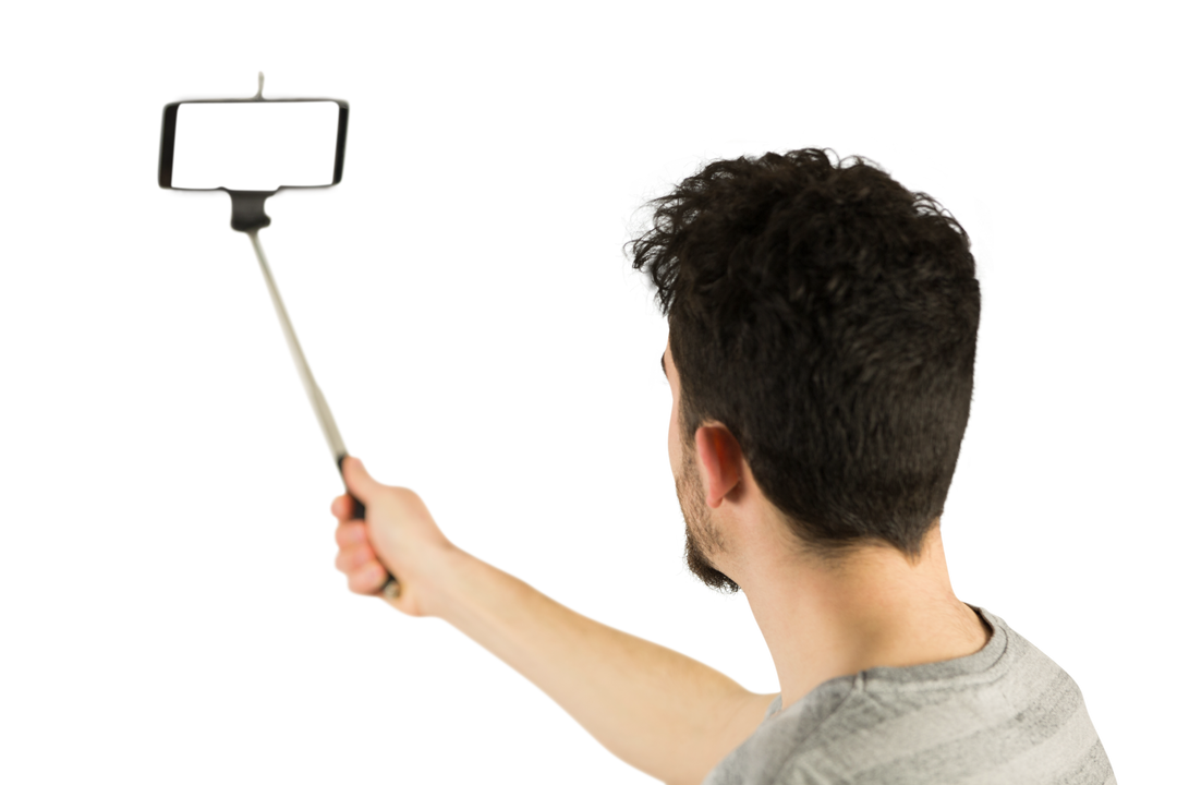 Casual man using transparent selfie stick technology in studio - Download Free Stock Images Pikwizard.com