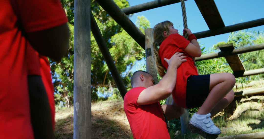 Young Girl Climbing Rope at Outdoor Adventure Course with Instructor - Free Images, Stock Photos and Pictures on Pikwizard.com