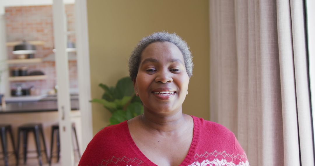Smiling Woman in Festive Sweater at Home