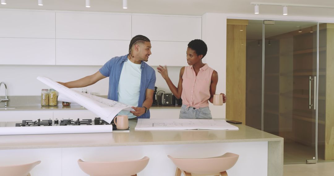 Diverse Couple Examining Blueprints in Modern Kitchen