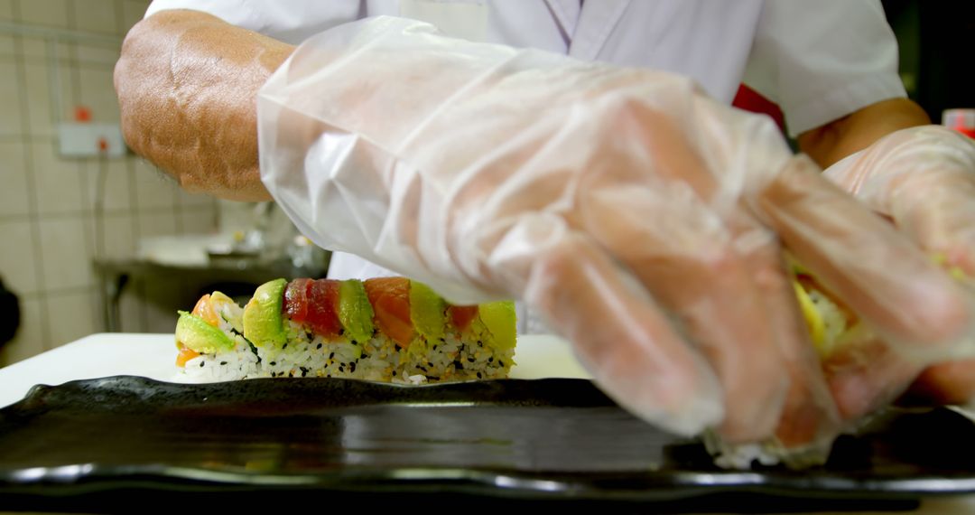 Chef Preparing Fresh Sushi Rolls in Kitchen with Gloves - Free Images, Stock Photos and Pictures on Pikwizard.com