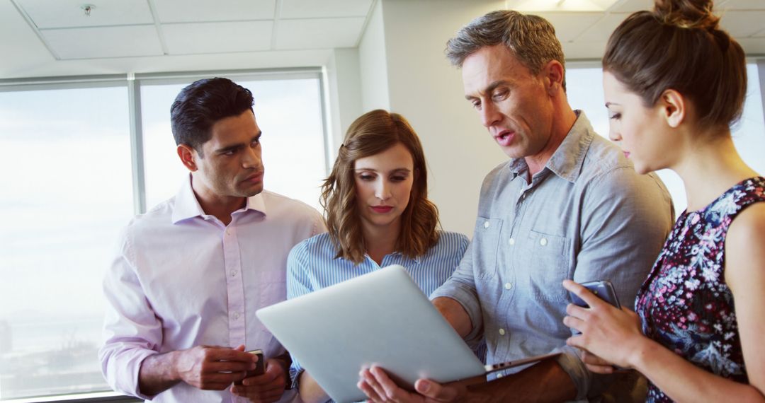 Dynamic Team Collaborating Over Modern Technology in Office