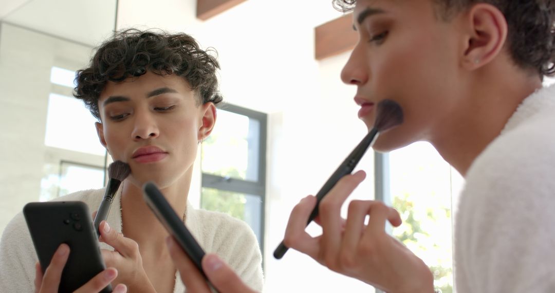 Man Perfecting Makeup Techniques in Modern Bathroom