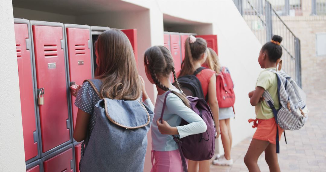 Schoolchildren Opening Lockers in Hallway During Morning - Free Images, Stock Photos and Pictures on Pikwizard.com