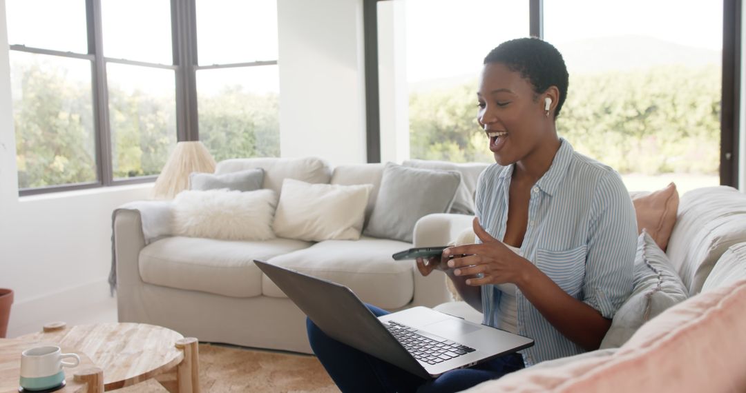 African American woman video chatting at home with laptop and smartphone - Free Images, Stock Photos and Pictures on Pikwizard.com