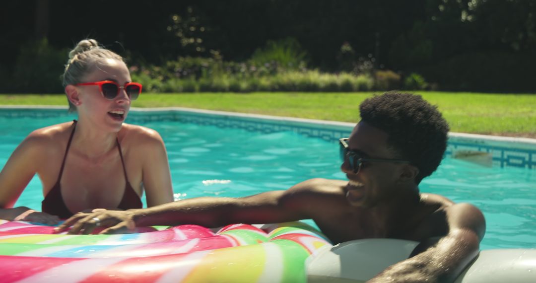 Friends Relaxing on Pool Float in Sunlit Backyard Pool
