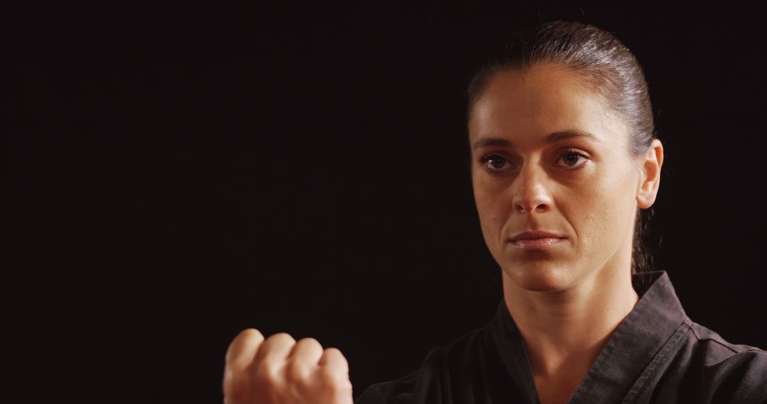 Confident Female Martial Artist in Uniform with Focused Expression - Free Images, Stock Photos and Pictures on Pikwizard.com