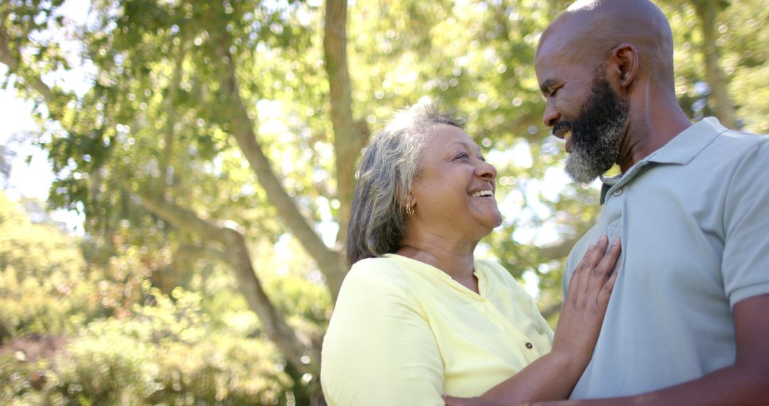 Smiling Senior Couple Embracing Outdoors in Tranquil Setting