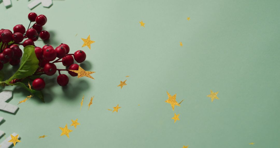 Festive Composition with Red Berries and Gold Stars on Green Background