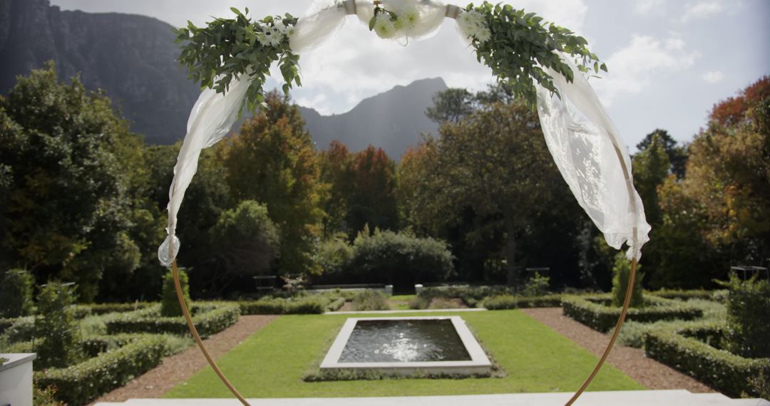 Decorated Wedding Archway in Scenic Garden with Mountains in Background - Free Images, Stock Photos and Pictures on Pikwizard.com