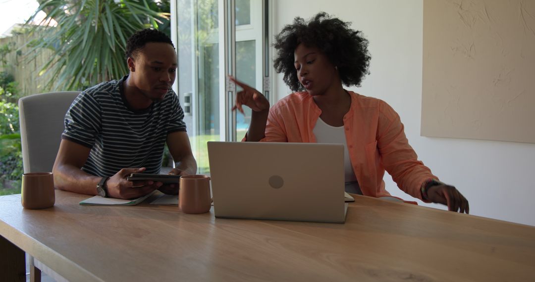 Mixed Race Couple Collaborating at Home in Stylish Workspace
