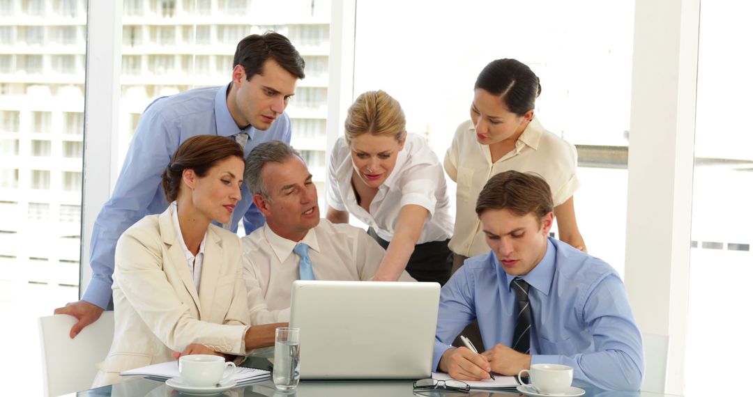 Energetic Business Team Collaborating on Laptop Inside Office