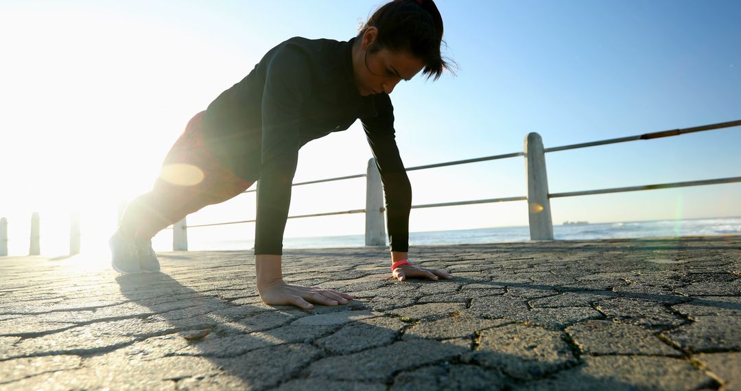 Woman Exercising Push-Ups Outdoors on Sunny Day - Free Images, Stock Photos and Pictures on Pikwizard.com