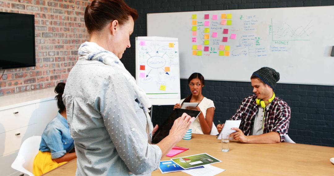 Businesswoman Utilizing Tablet During Collaborative Meeting