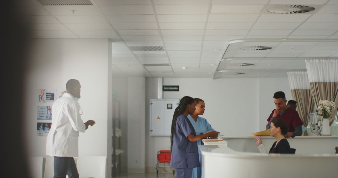 Healthcare Professionals Working in Hospital Reception Area - Free Images, Stock Photos and Pictures on Pikwizard.com