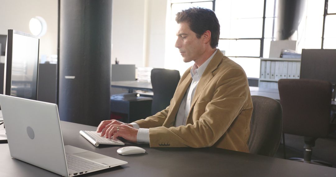 Focused Business Professional Typing on Keyboard in Modern Office