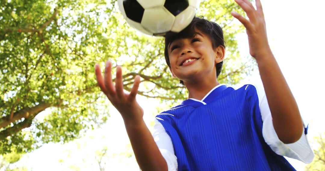 Excited Boy Playing with Soccer Ball Outdoors - Free Images, Stock Photos and Pictures on Pikwizard.com