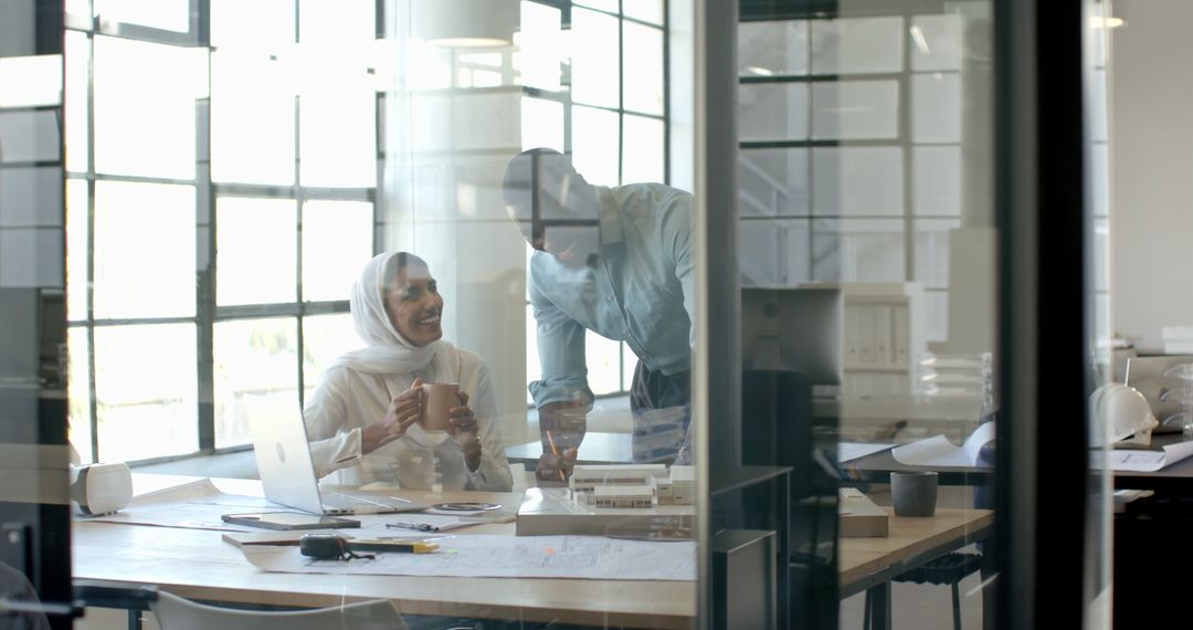Modern Colleagues Collaborating in Office Over Coffee