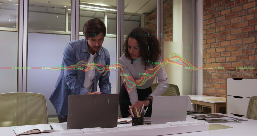 Multiracial Coworkers Collaborating on Data Analysis in Office