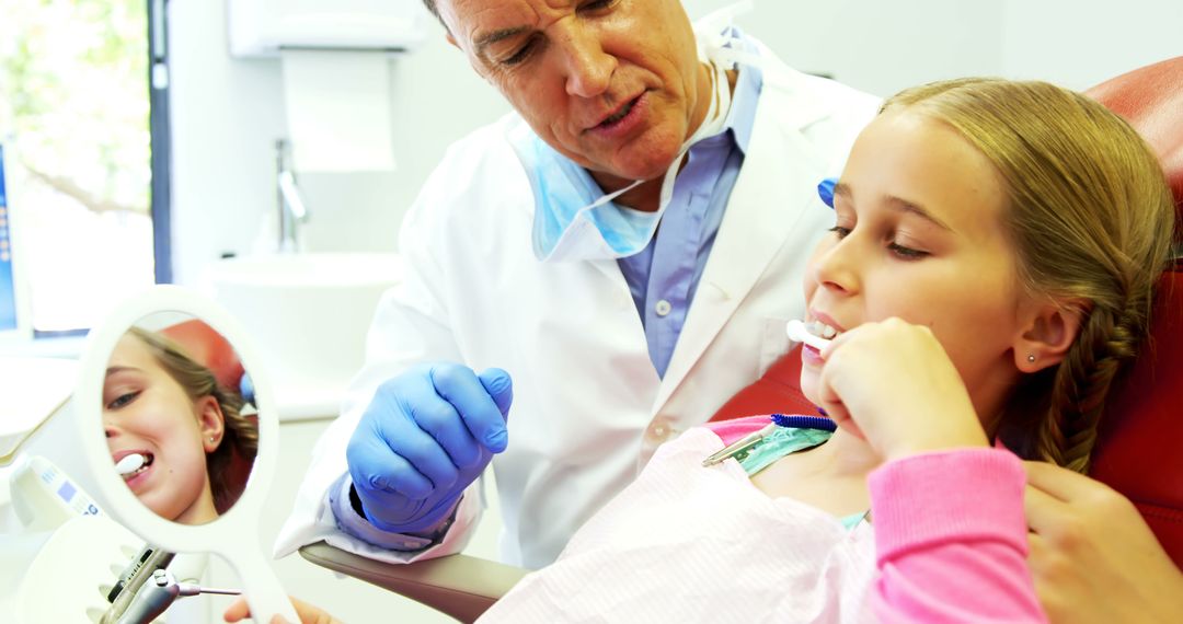 Dentist Teaching Young Girl Proper Brushing Techniques During Appointment - Free Images, Stock Photos and Pictures on Pikwizard.com