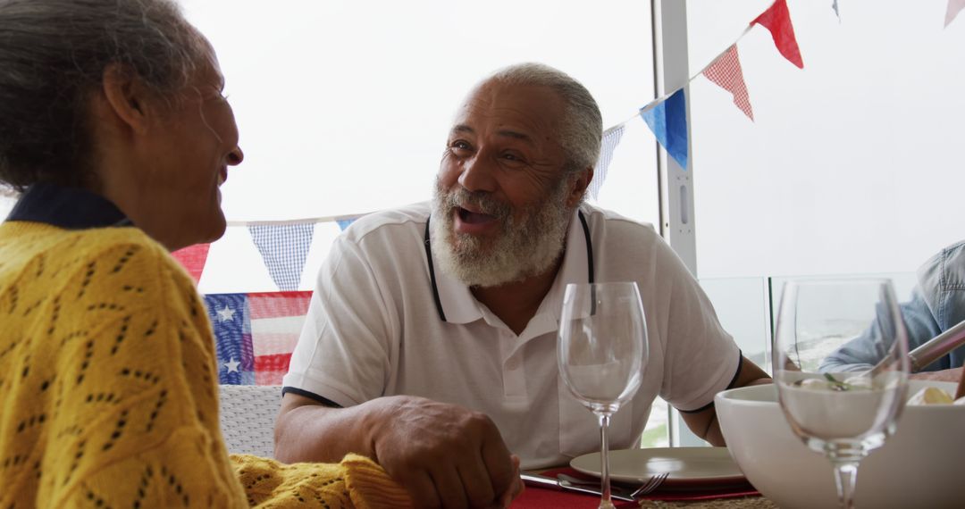 Biracial Family Dining with American Flags Decorating Table