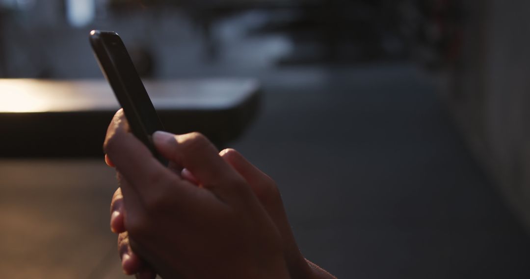 Close-Up Biracial Woman in Gym Texting on Smartphone Break