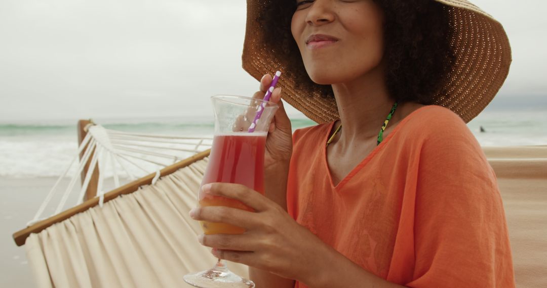 Relaxed Woman Enjoying Drink on Tropical Beach - Free Images, Stock Photos and Pictures on Pikwizard.com