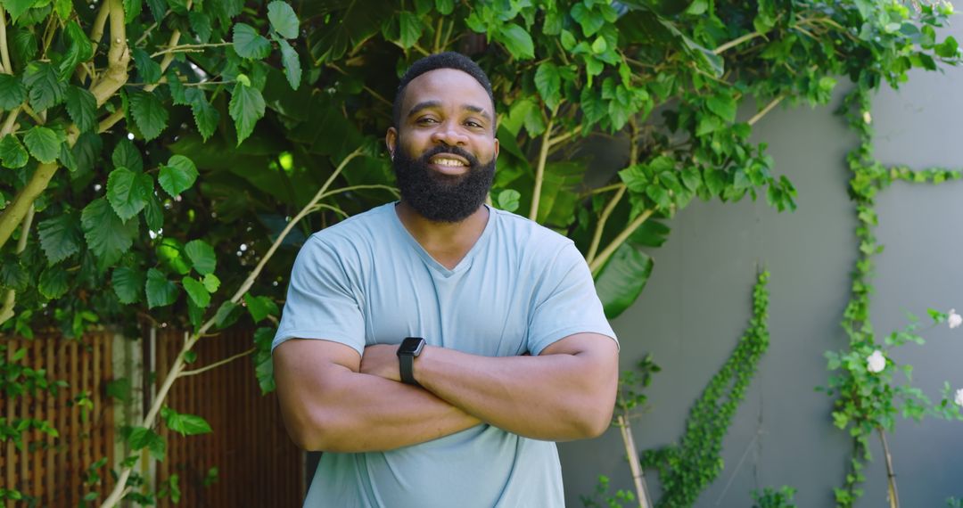 Smiling Man with Black Smartwatch Relaxing Outdoors