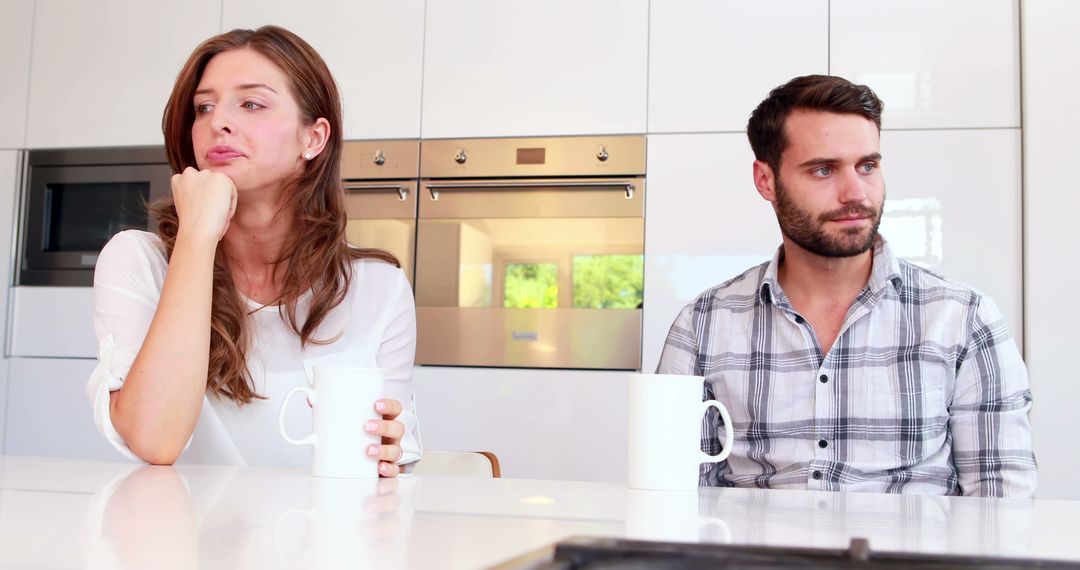 Couple Experiencing Tension in Contemporary Home Kitchen - Free Images, Stock Photos and Pictures on Pikwizard.com