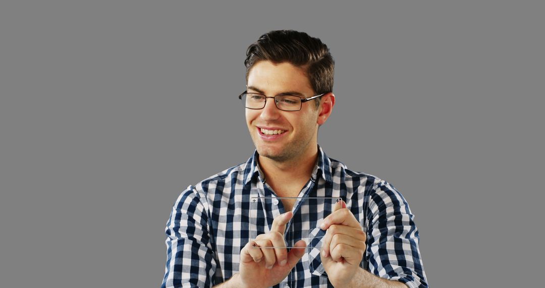 Man Wearing Plaid Shirt Using Invisible Touchscreen Interface - Free Images, Stock Photos and Pictures on Pikwizard.com