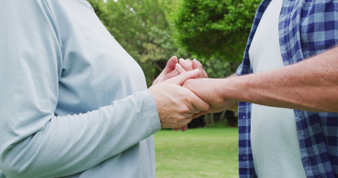 Image of midsection of caucasian female and male senior friends holding hands in garden - Free Images, Stock Photos and Pictures on Pikwizard.com