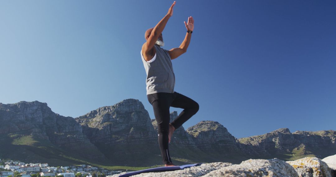 Man Practicing Yoga Outdoors in Mountainous Landscape - Free Images, Stock Photos and Pictures on Pikwizard.com